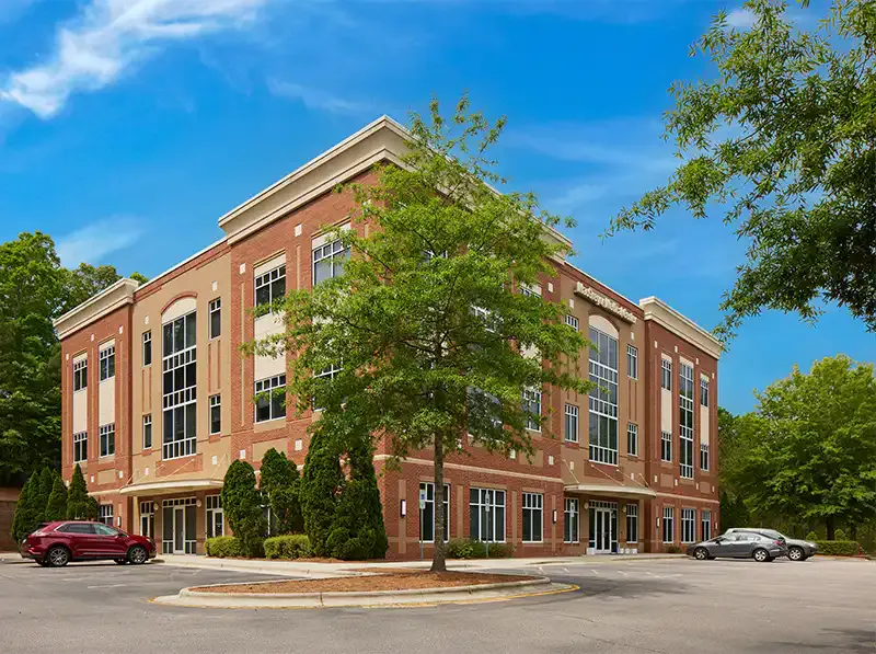 The three-story red-brick medical office building at 160 Macgregor Pines Dr, Ste 100, Cary, NC 27511, home to NOOR Dermatology & Aesthetics.